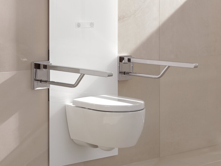 HEWI S 50 WC module A white, wall-mounted WC module with two hinged support rails on the left and right, set against a beige tiled wall