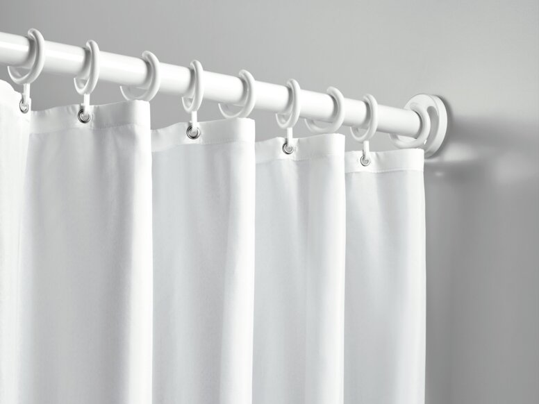HEWI Range 801 curtain rail A shower curtain with white rings, hung on a white curtain rail against a light grey wall