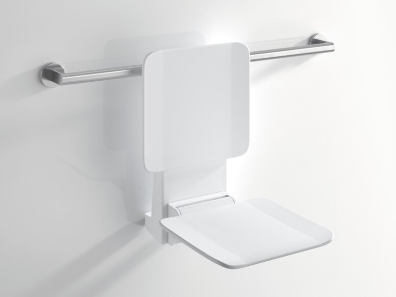 HEWI System 900 removable hanging seat White hanging seat with a backrest and folded-down seating surface, attached to a horizontal stainless steel support rail against a white wall