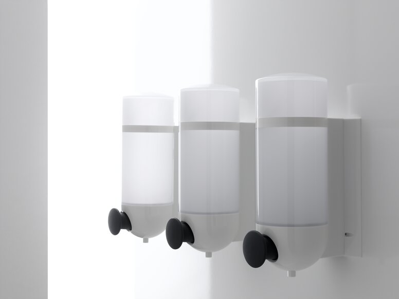 Drei HEWI Seifenspender mit zylindrischem Design in Weiß aus Polyamid und Drucktaste in Anthrazit 