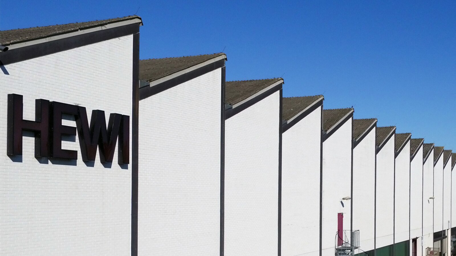 HEWI factory HEWI factory with white façade, "HEWI" lettering and shed roof